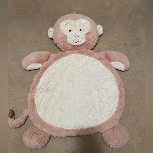 Monkey lay on pillow for baby